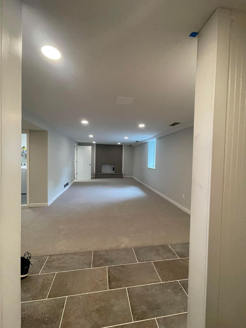 Finished basement with carpet, tile entry and recessed lighting