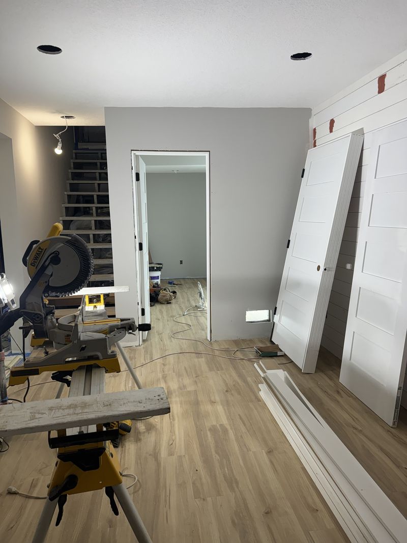 Miter saw, new interior doors and flooring on an active job site
